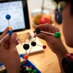 Man holding examining molecular model