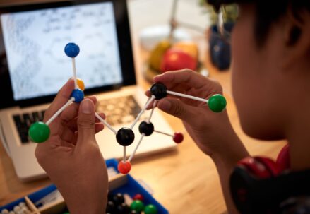 Man holding examining molecular model