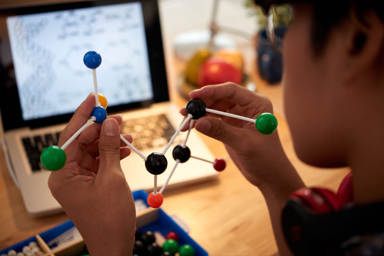 Man holding examining molecular model
