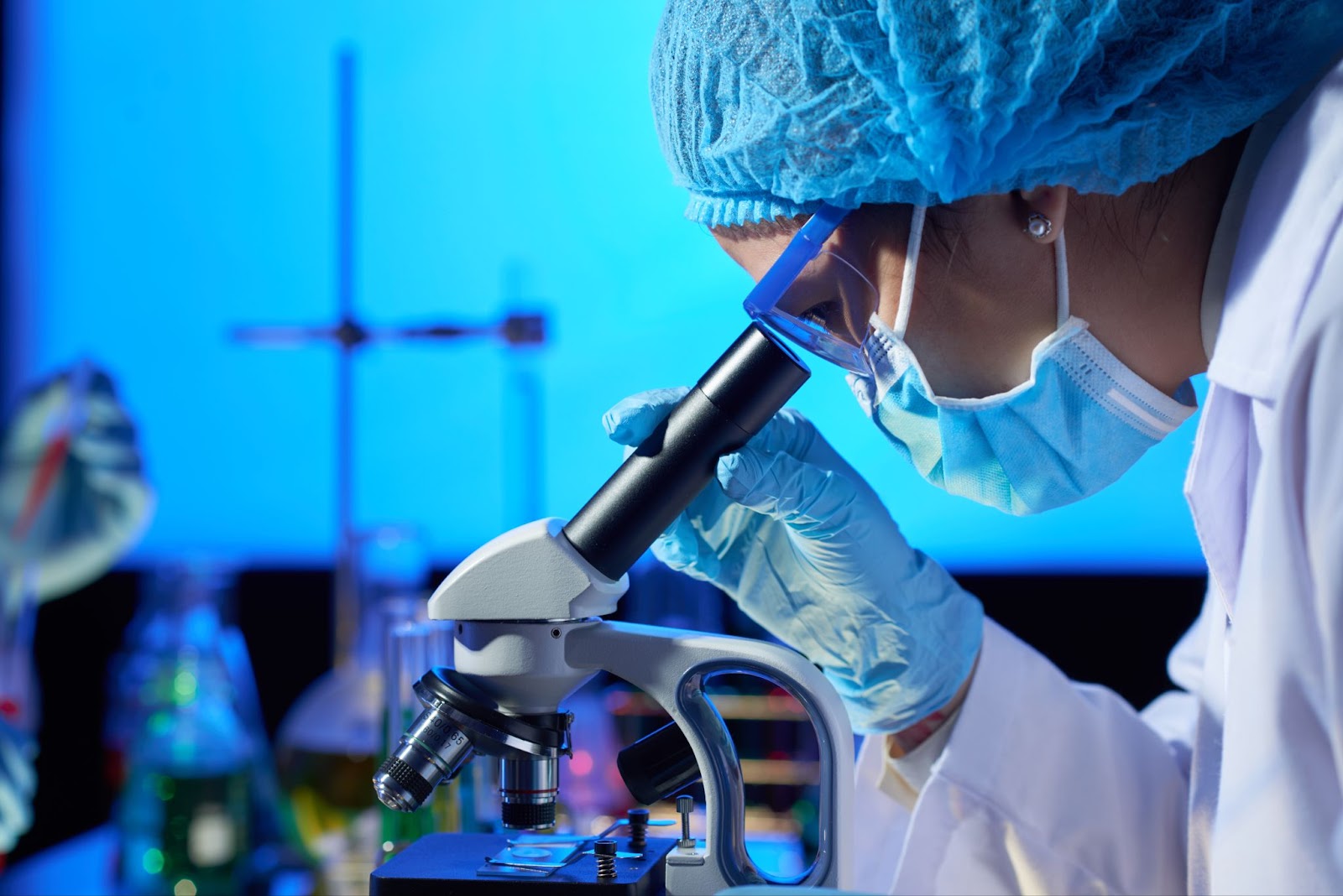 Woman examining sample with microscope