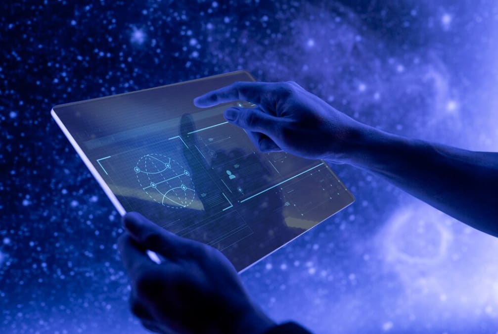 Hands using a futuristic tablet with space-themed holographics