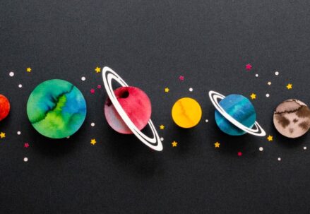 Planets depicted as colorful circular cutouts with stars on a black backdrop