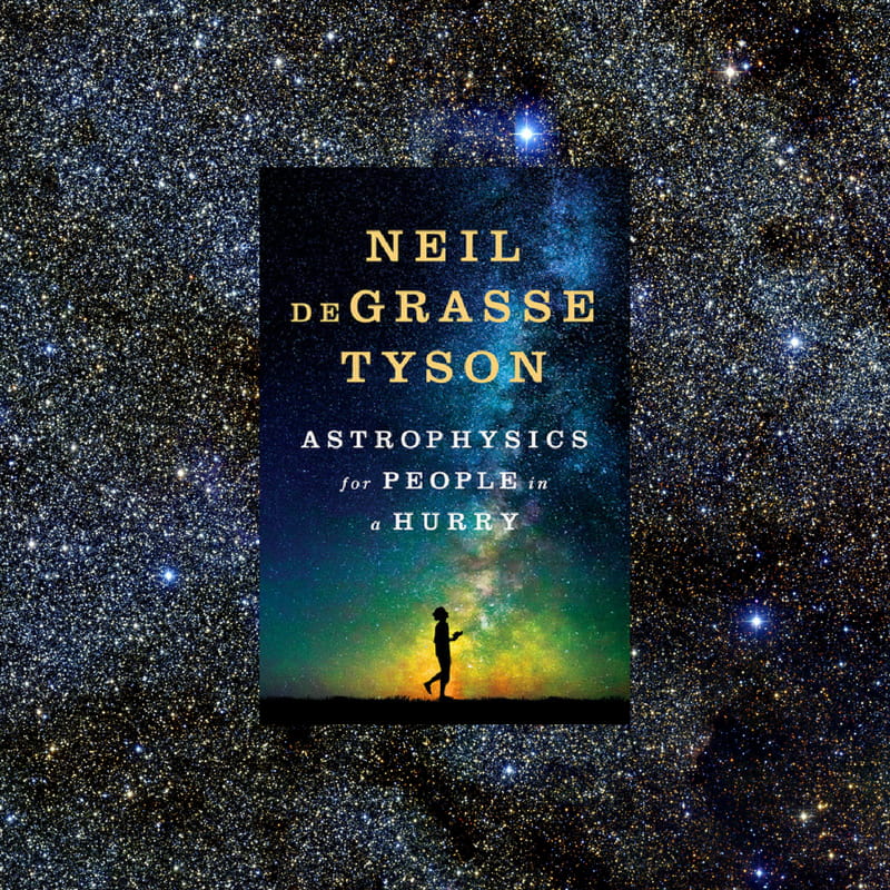 A book on astrophysics against the backdrop of a starry sky